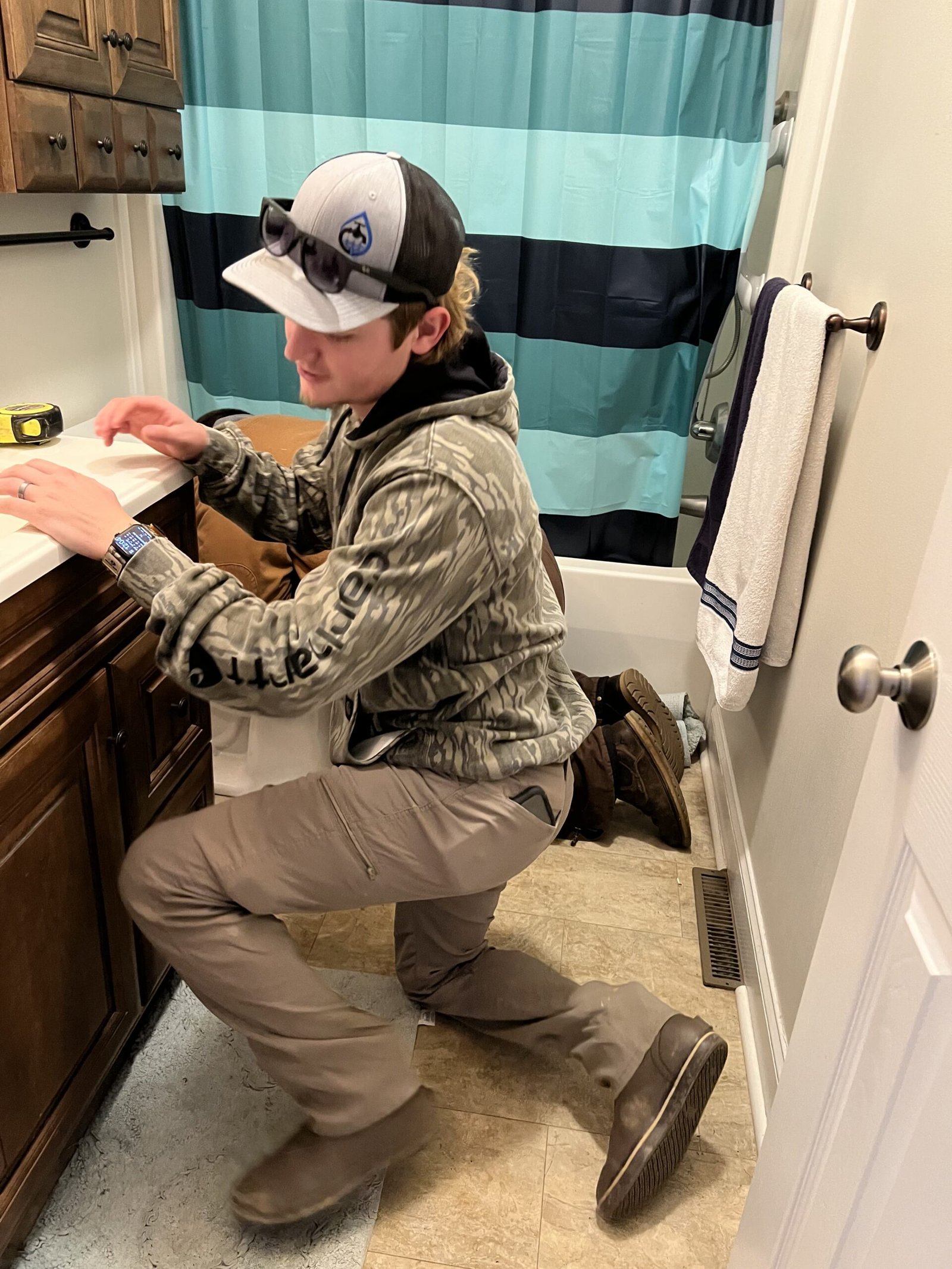 Troy Robinson working in a bathroom Trusted plumbing services in Wilkes NC: Troy Robinson of NBR Plumbing LLC working in a customers bathroom in North Carolina